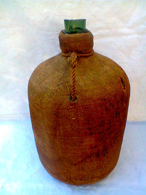 Demijohn dressed in burlap and padded cork