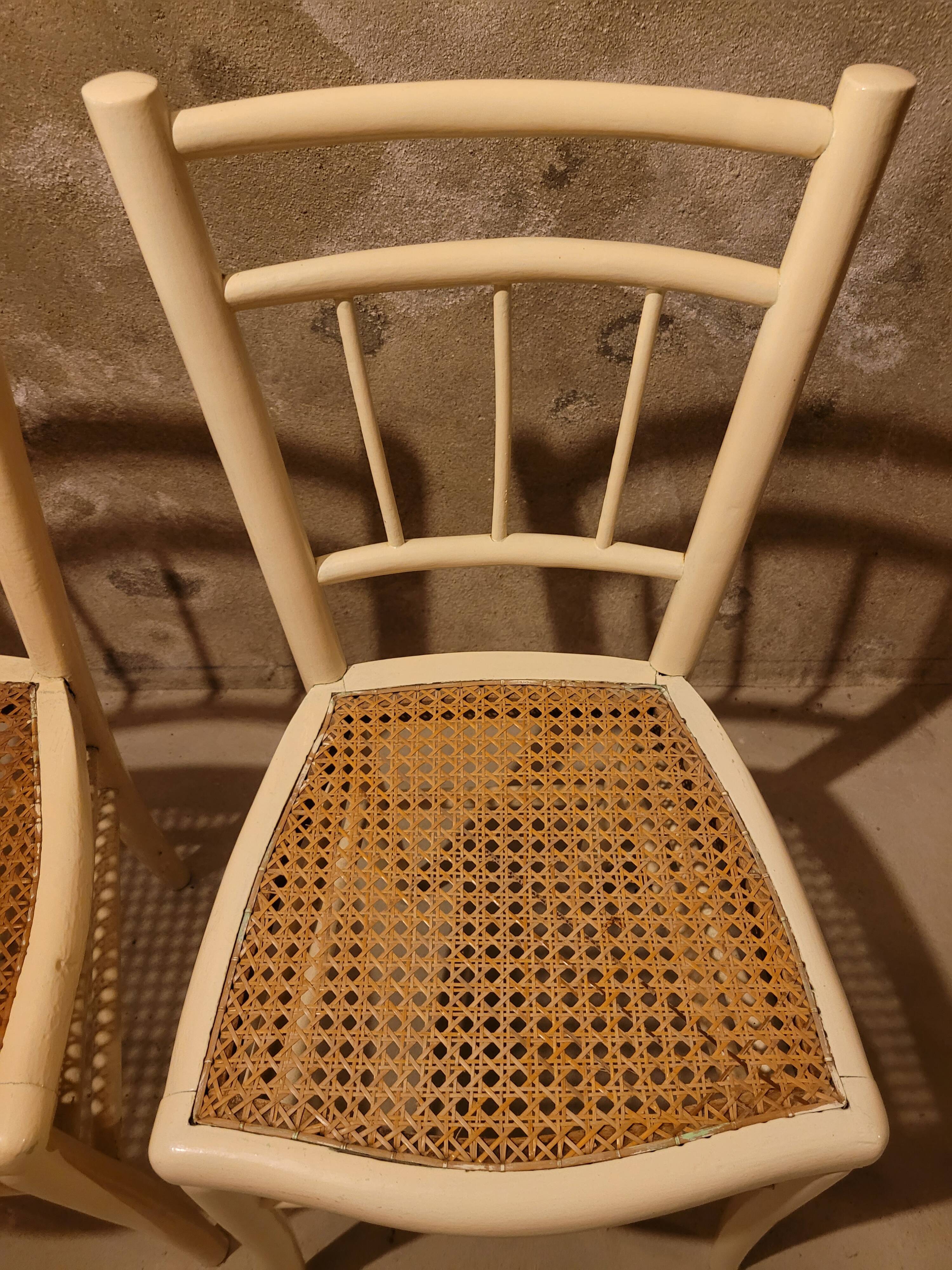 2 white wooden chairs