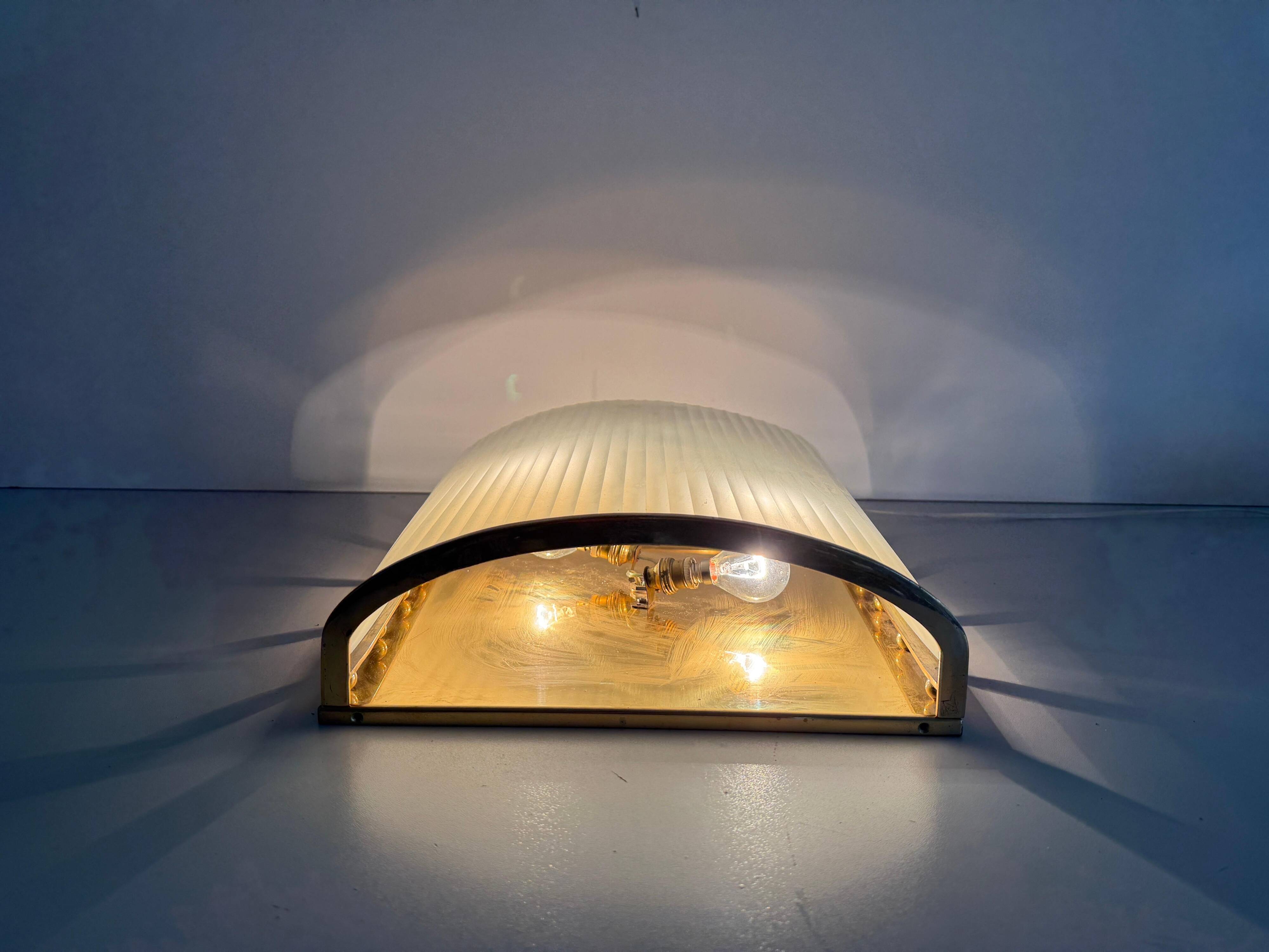 Large heavy glass wall light with a brass frame from the mid-century, 1950s, Italy.