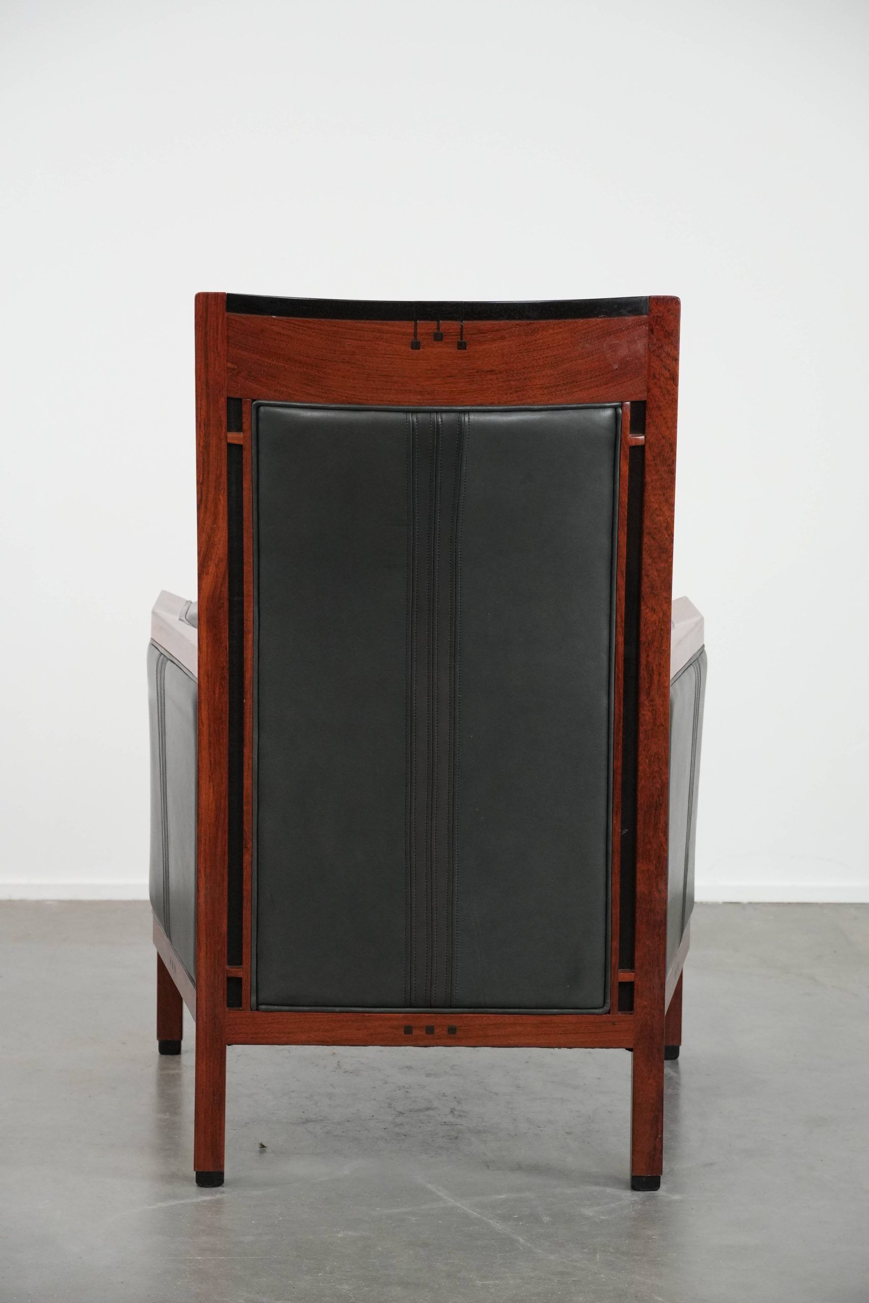 Black cowhide leather and wooden Art Deco design armchair