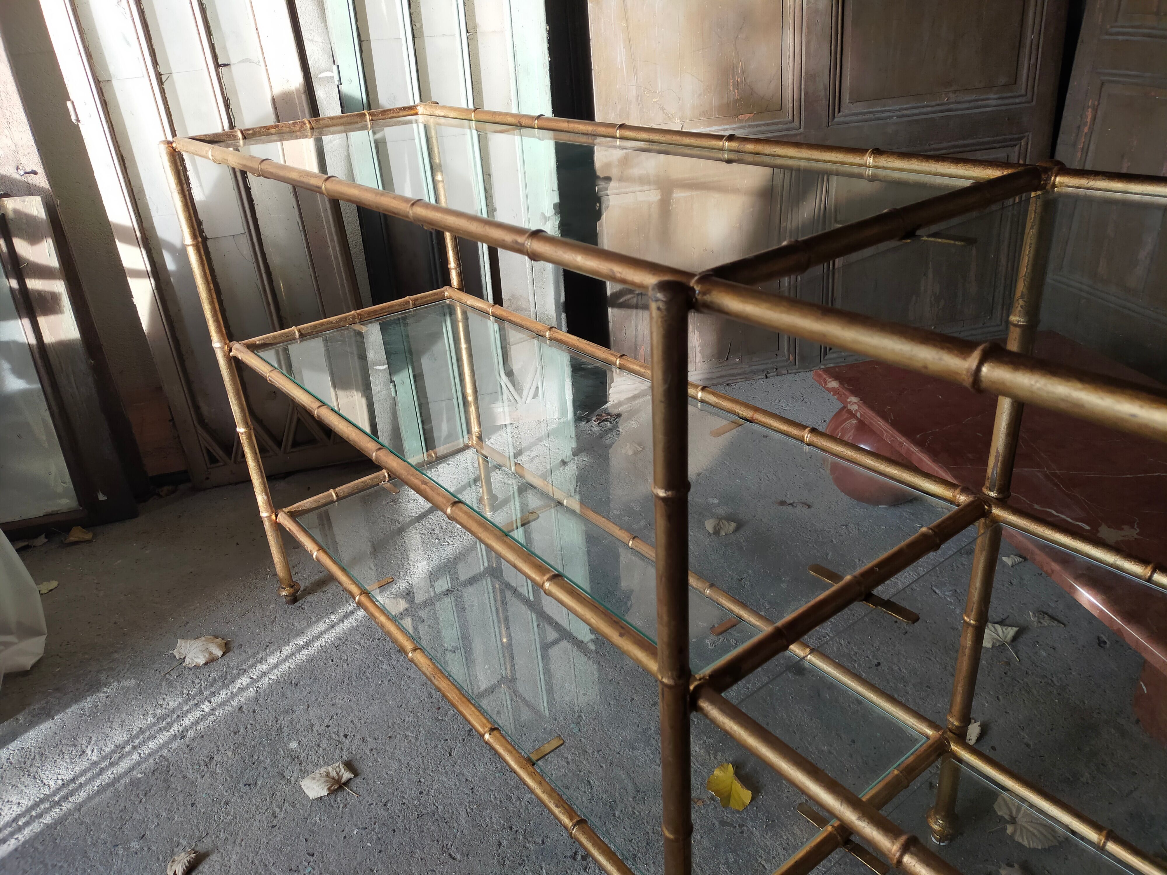 Console in gilded metal and glass