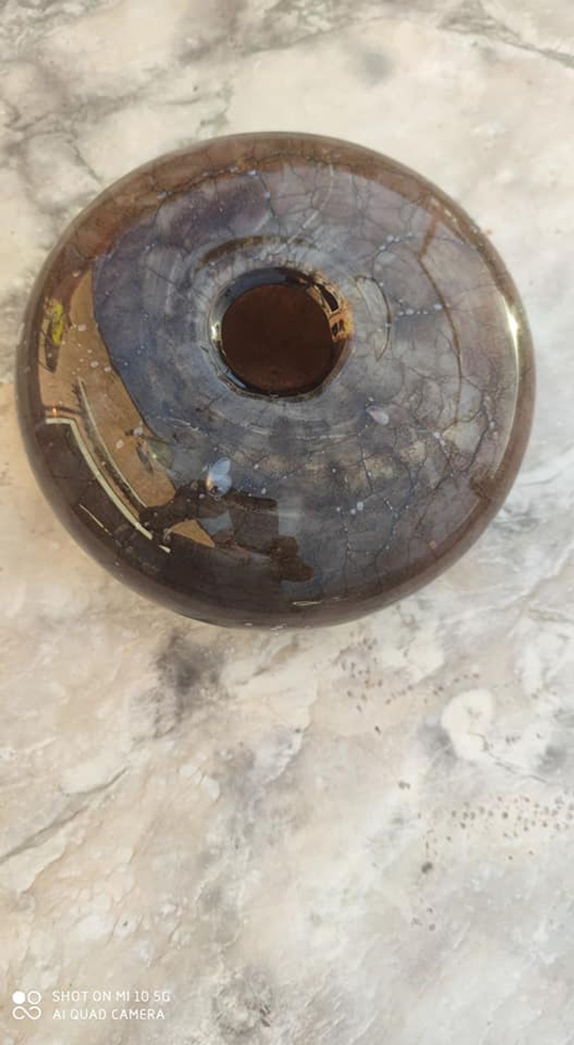 Flattened spherical vase made of glass paste