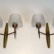 Pair of bronze wall sconces with worked glass reflectors. Stilnovo