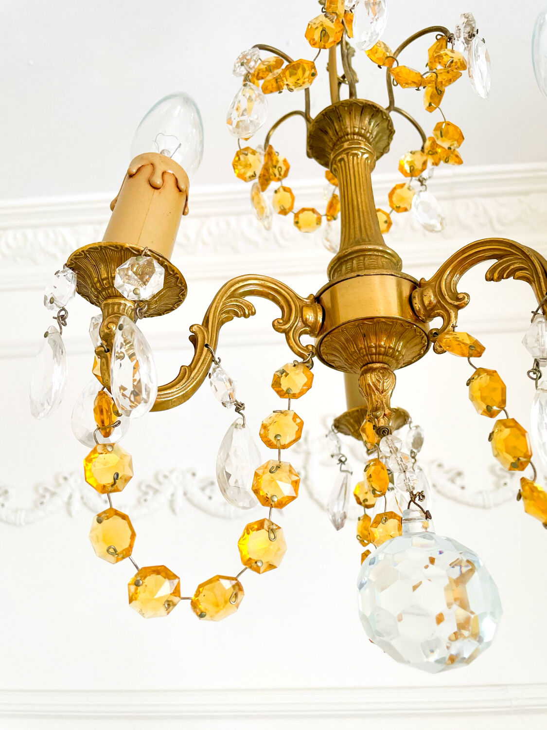 Small vintage brass chandelier with amber crystal pendants.