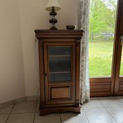 Small glass-fronted accent cabinet in cherry wood.