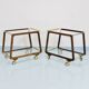 May include: A mid-century modern bar cart with a dark wood frame and two c