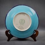 Longwy plate with polychrome enamels, decorated with the "City of Iron" motif.