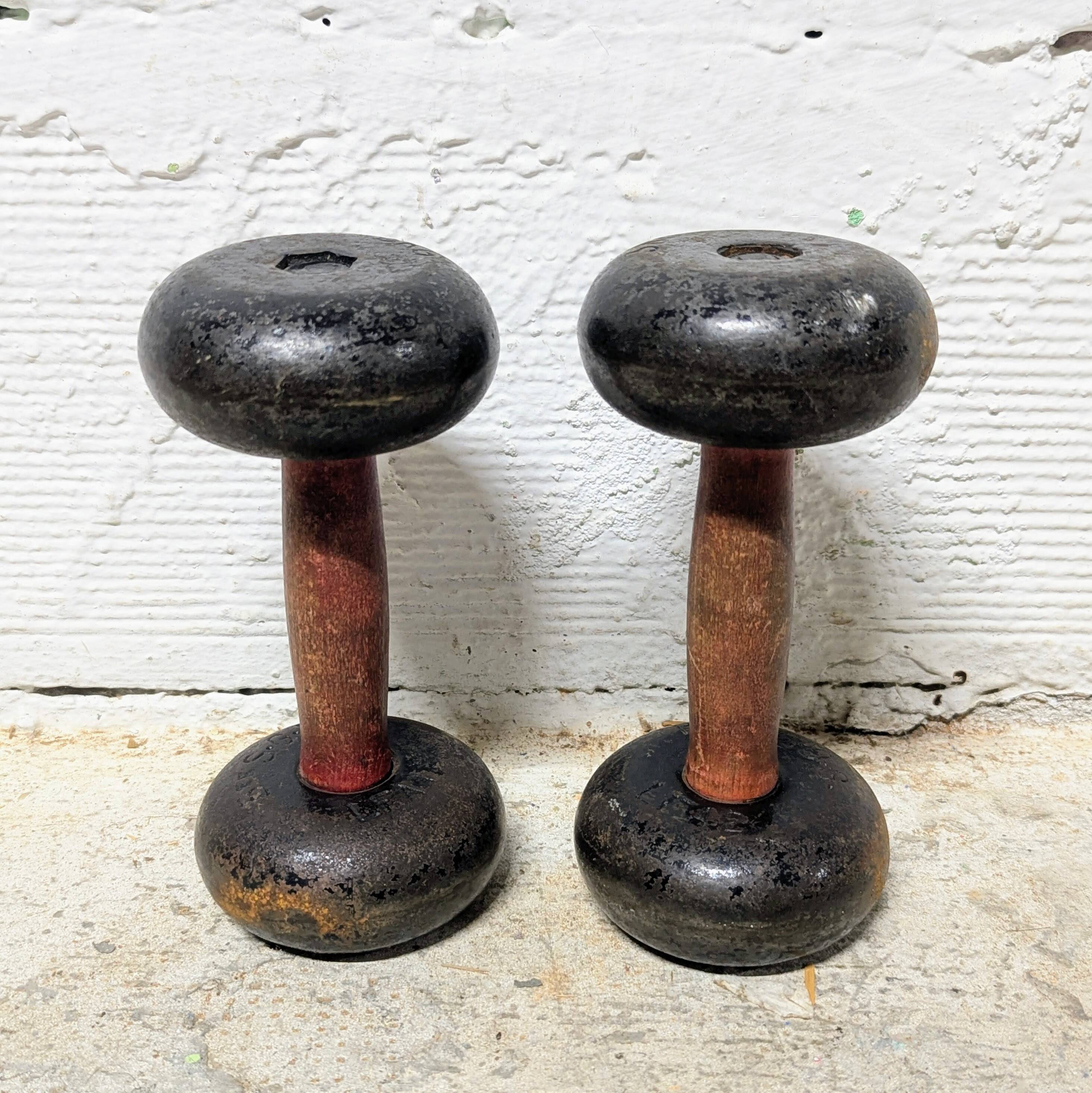Pair of vintage cast iron and wood dumbbells