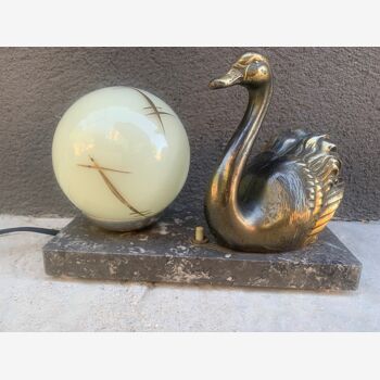 Art Deco lamp on marble terrace decorated with a golden swan