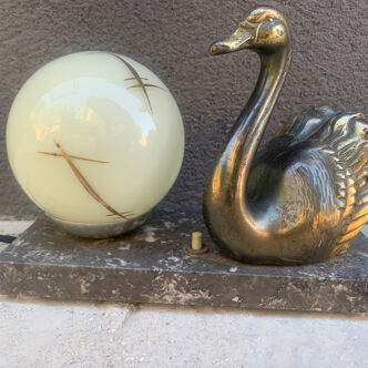 Art Deco lamp on marble terrace decorated with a golden swan