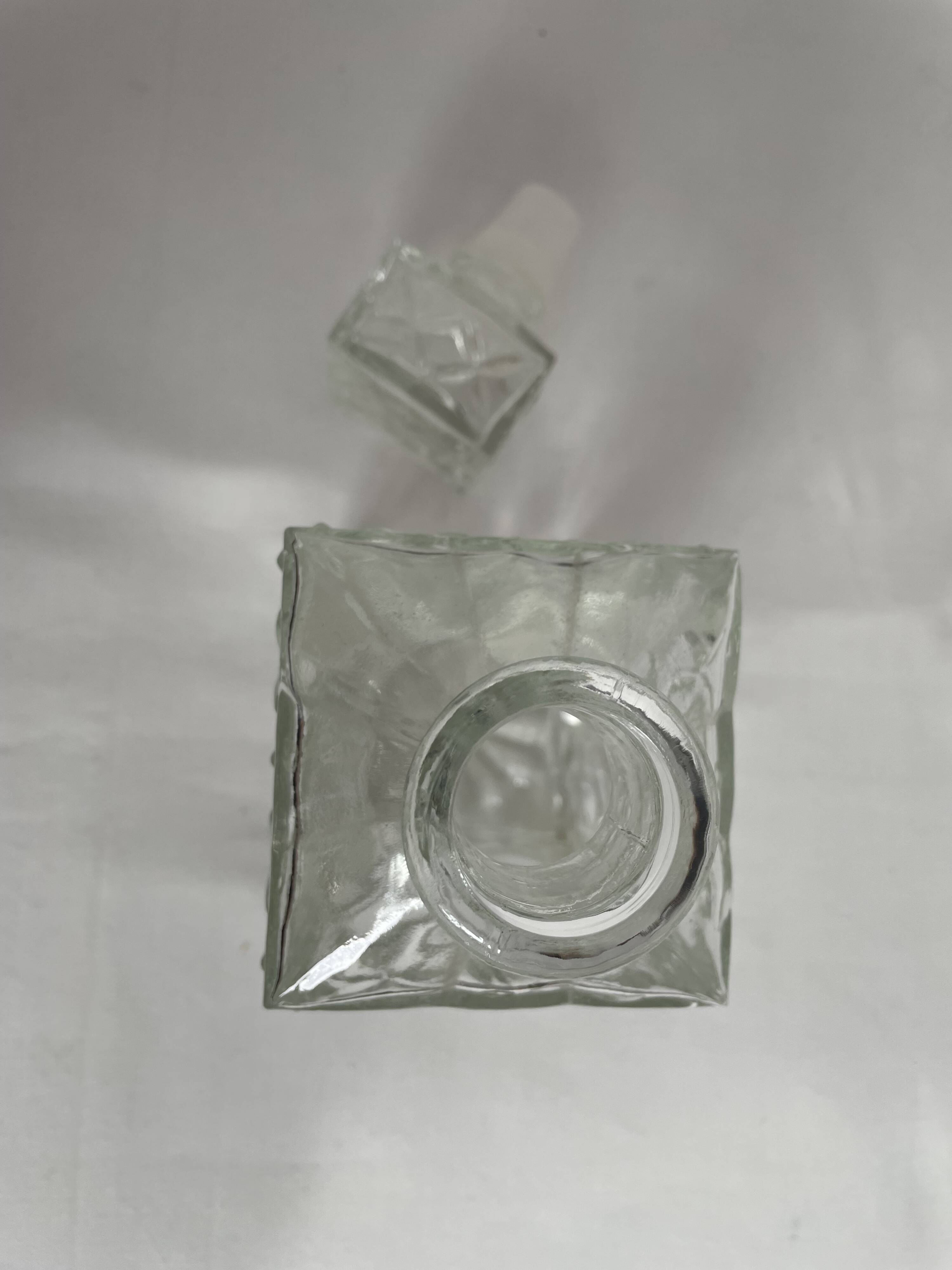 Molded glass carafe, 1960s-1970s, stylized flower decoration, oval, square base, stopper, rosette