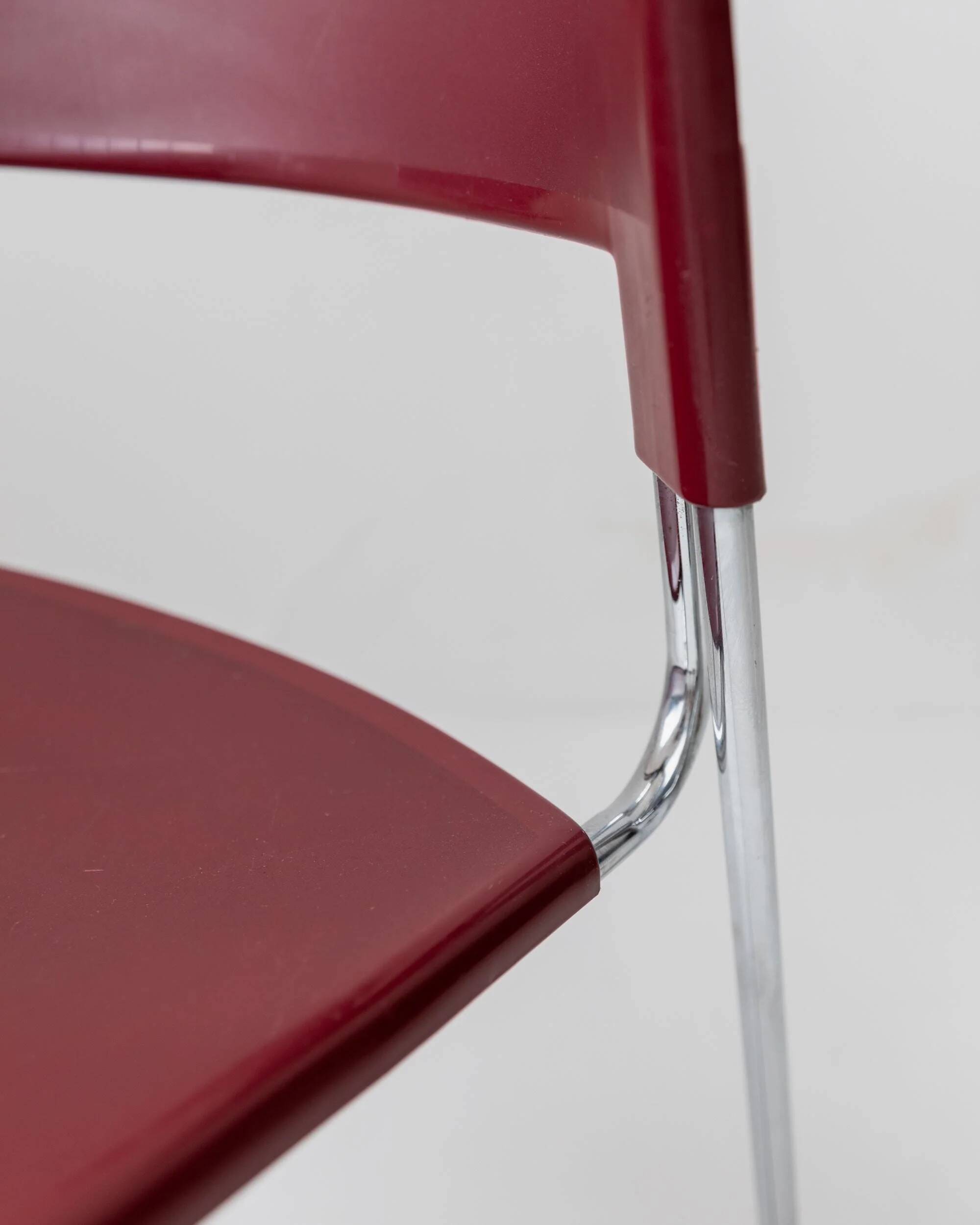 Vintage dining chair from the 1980s by Paolo Favaretto for Assisa, stackable, design Italy 1986 - chrome and red plastic - a classic of design.