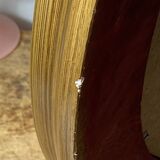 Oval-shaped wooden mirror in gold color