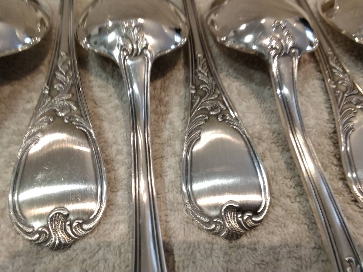 12 silver-plated metal soup spoons, Ercuis Dubarry model.