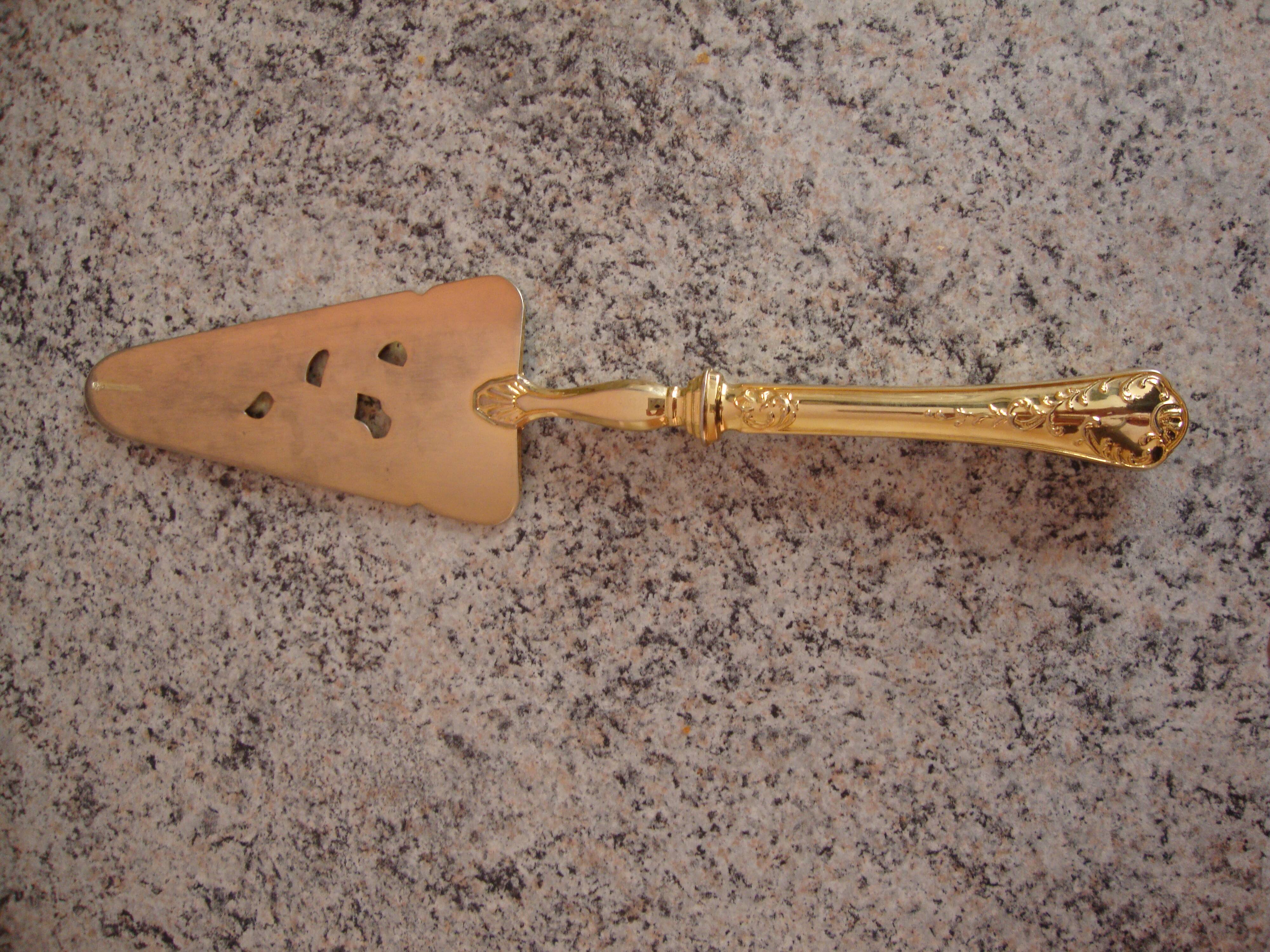 Old gold metal pie shovel
