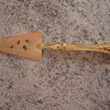 Old gold metal pie shovel
