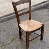 Solid wood chair in dark oak with rush seating, Louis Philippe style.