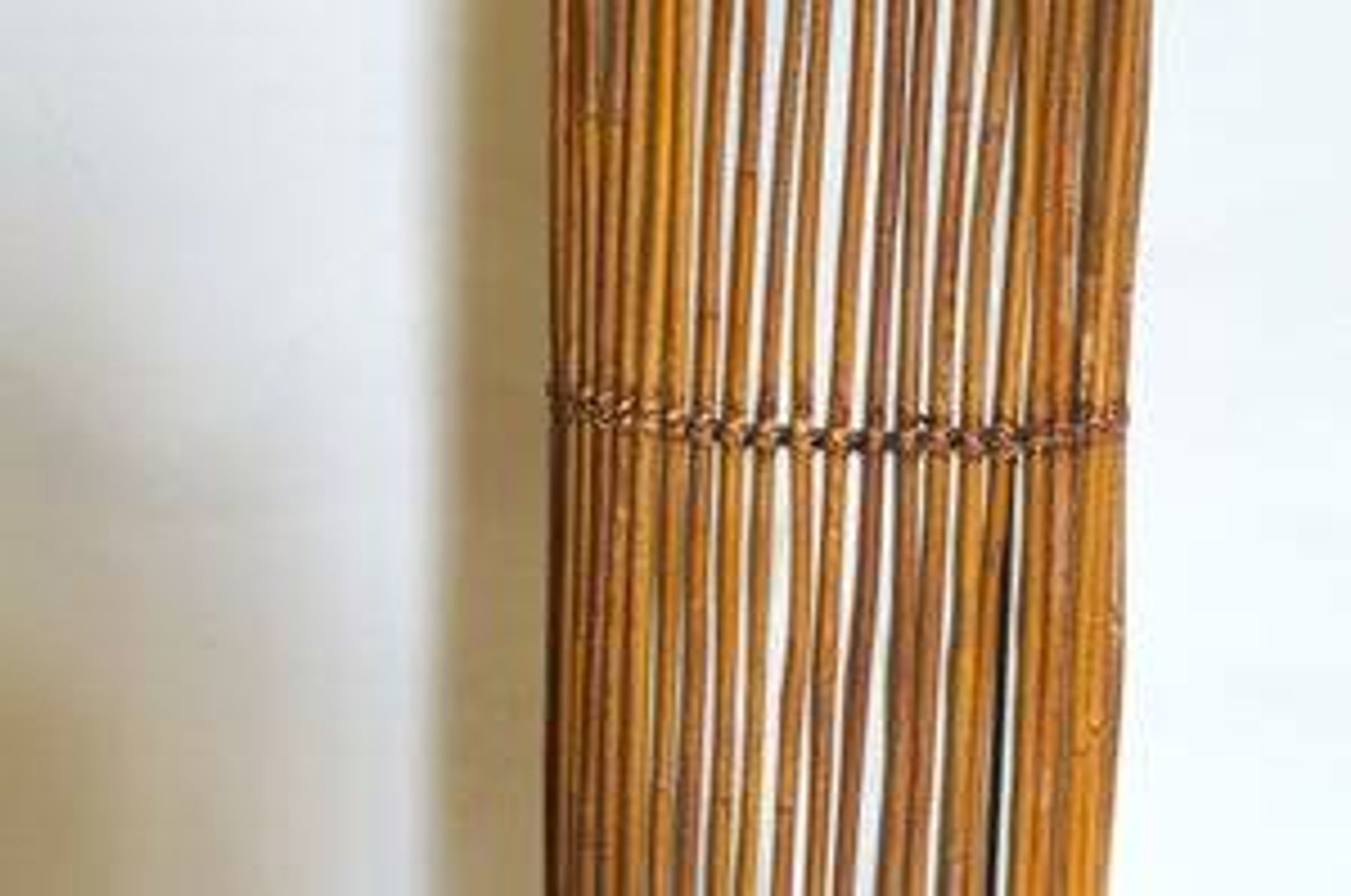 Mid-century rattan floor lamp, in the style of Louis Sognot.