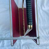 Vintage magazine rack in red skai with gold metal frame and plastic handle