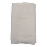White flat sheet with AG monogram