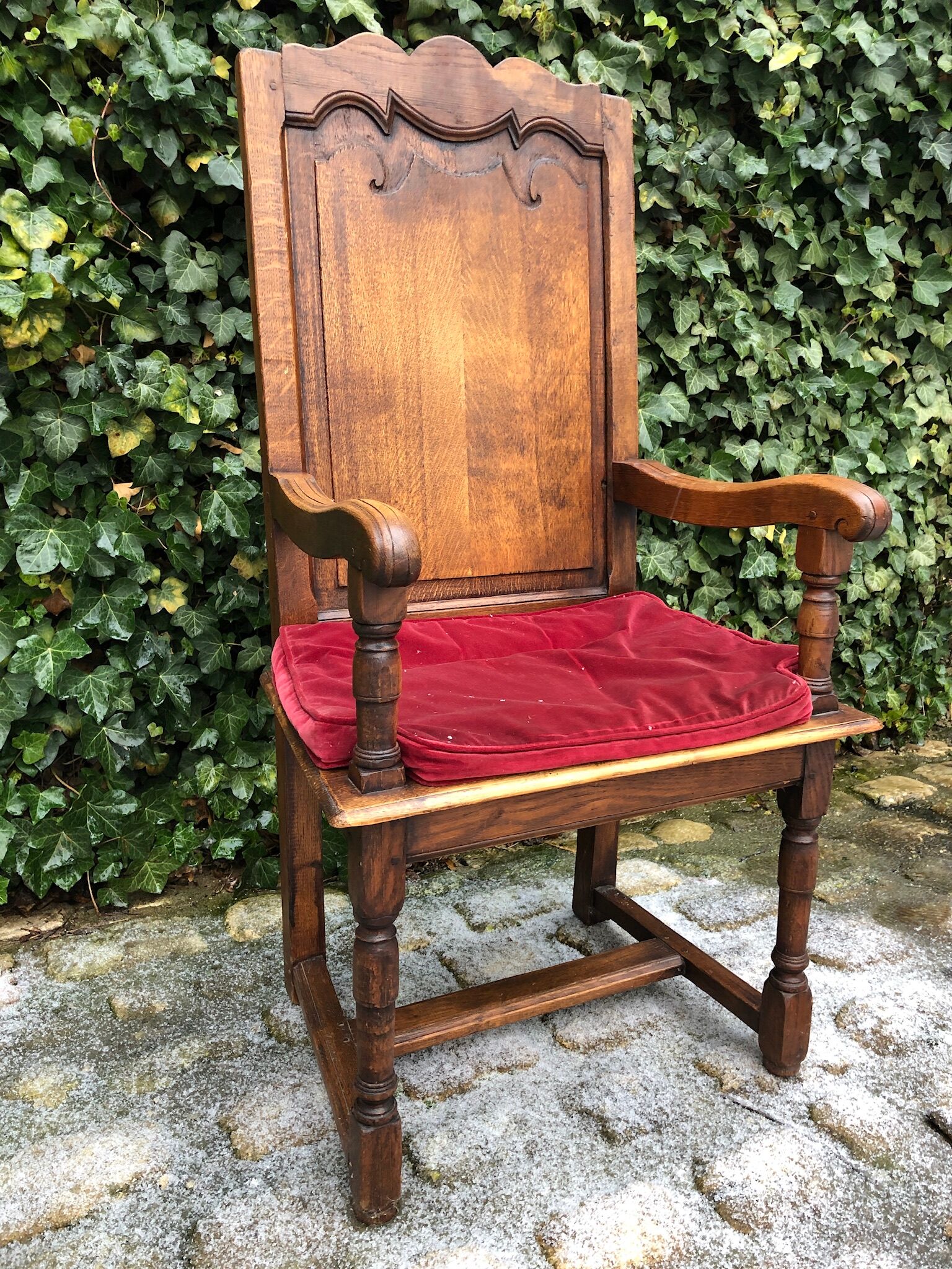 Wooden armchair with velvety red cushion