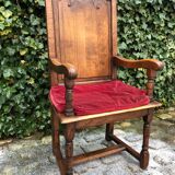 Wooden armchair with velvety red cushion