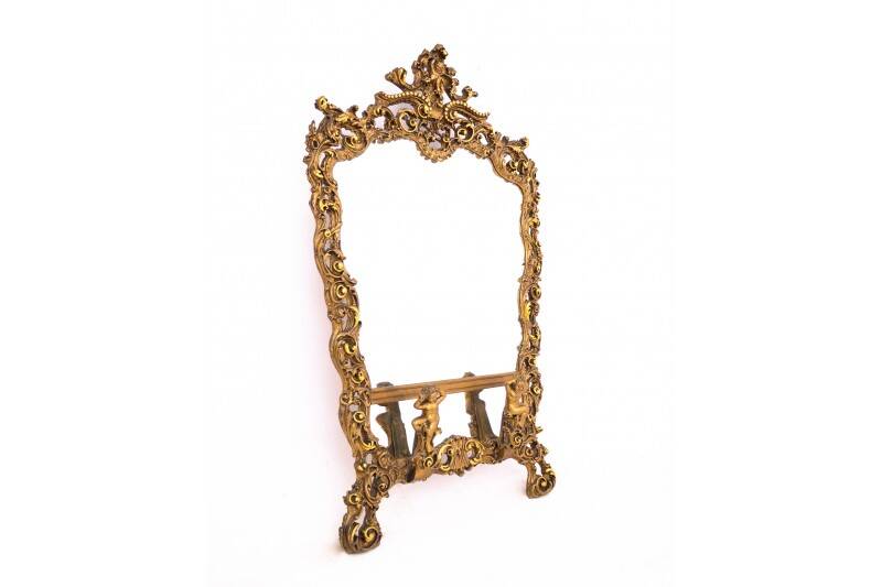 A large mirror in a gold frame, Italy, first half of the 20th century.