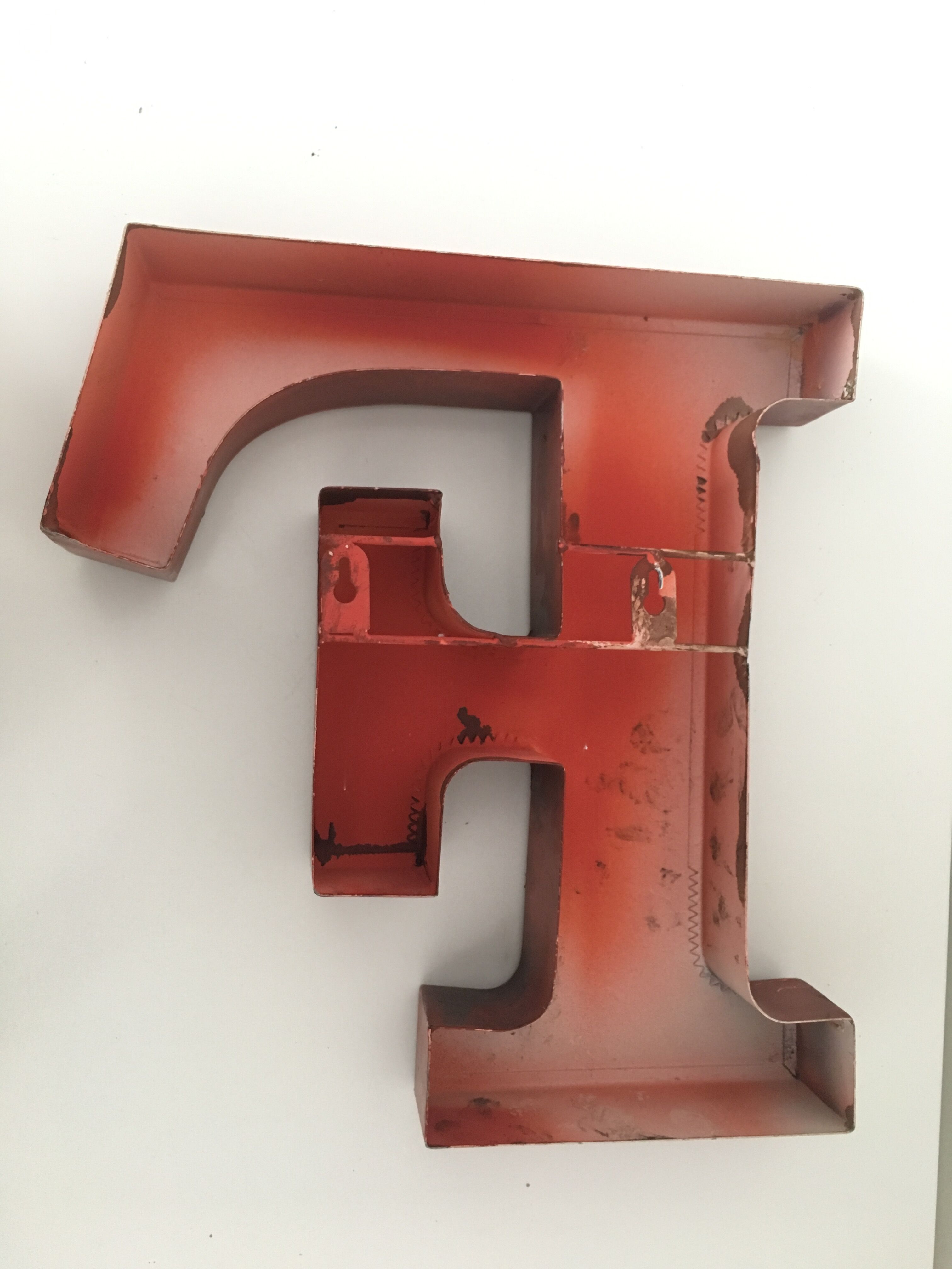 Red metal "F" sign letter