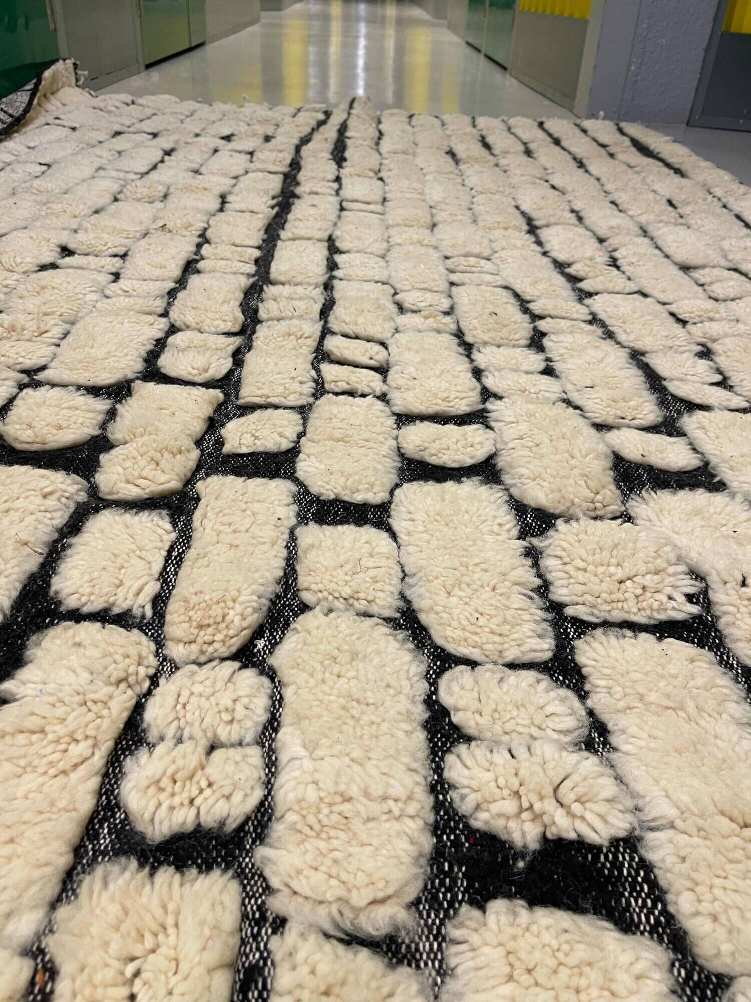 Large cream and black checked Berber rug, 280 × 200 cm.