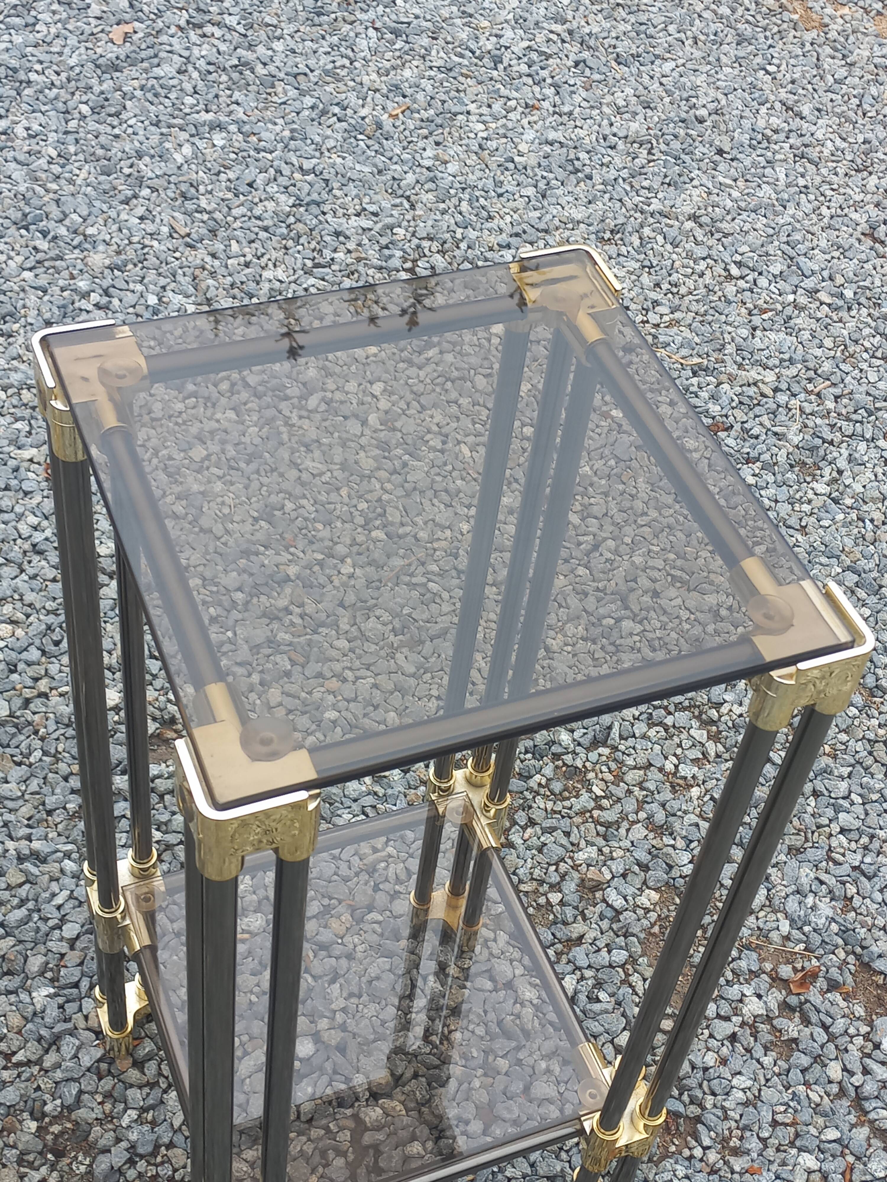 Pair of Hollywood Regency side tables in gold metal and smoked glass.
