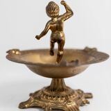 Vintage brass ashtray from the 1940s with a nude boy figurine on a footed base.