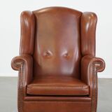 Cognac-colored leather wingback chair in English style
