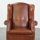 Cognac-colored leather wingback chair in English style
