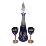 Cobalt blue double crystal service, consisting of a decanter and two matching glasses.
