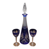 Cobalt blue double crystal service, consisting of a decanter and two matching glasses.