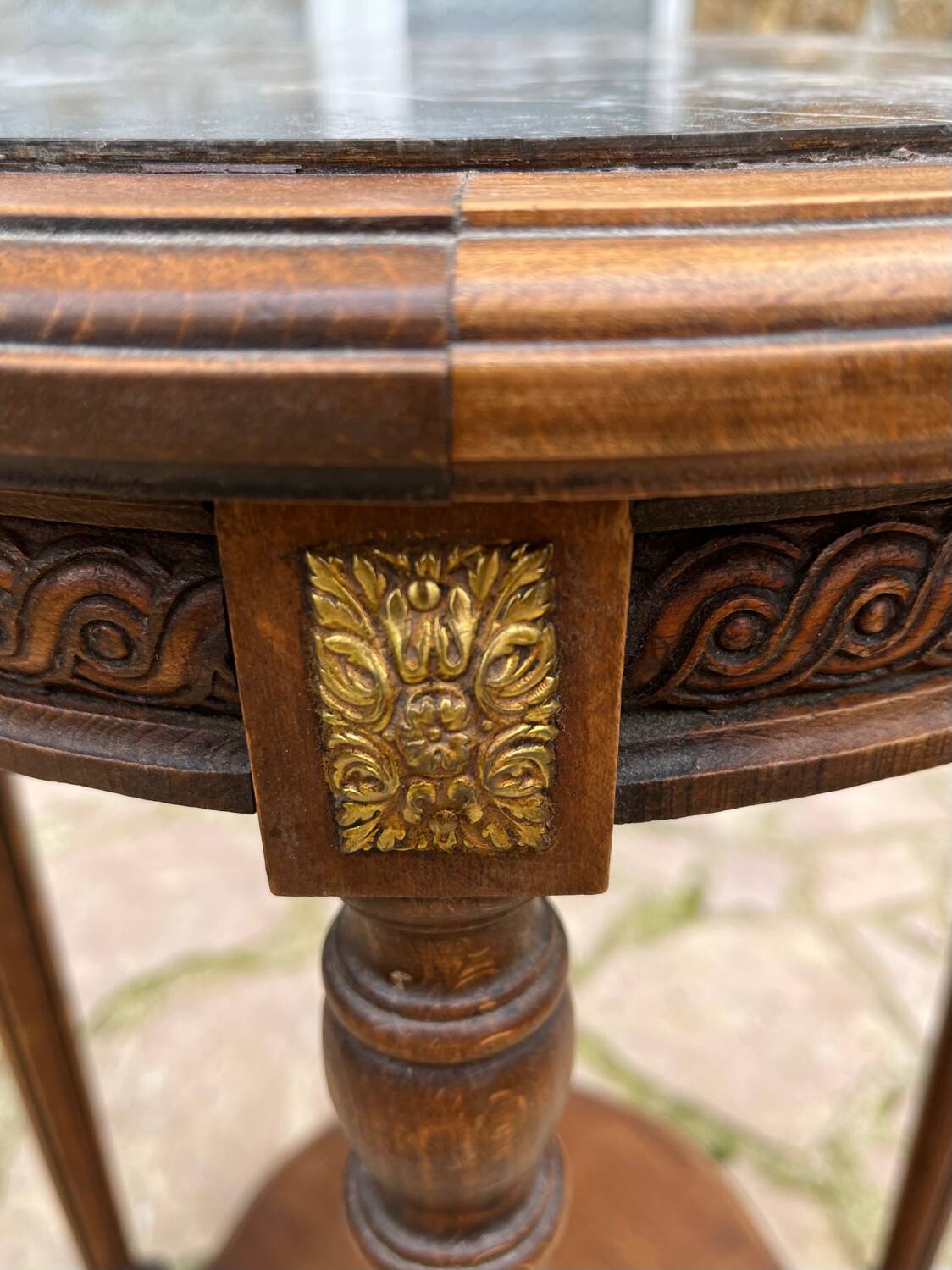Old wooden pedestal table with marble top