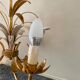 Golden metal chandelier decorated with flowers