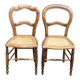 Two Louis Philippe cane chairs in solid carved wood from the 20th century