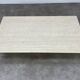 Rectangular travertine coffee table with central leg
