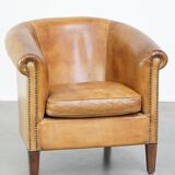 Comfortable, cozy, warm colored sheepskin club chair finished with decorative nails