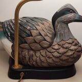 Decorative table lamp with a sculpted duck-shaped base and painted finish.