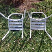 pair of white metal chairs, Tolix style