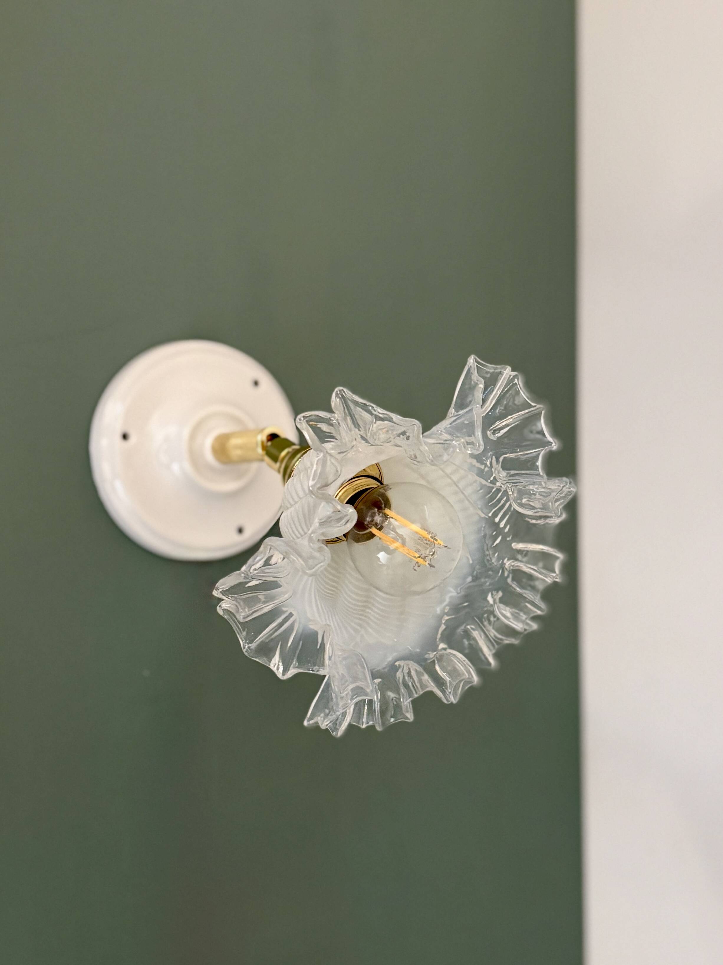 Vintage tulip glass wall light in transparent, slightly pearlescent white.