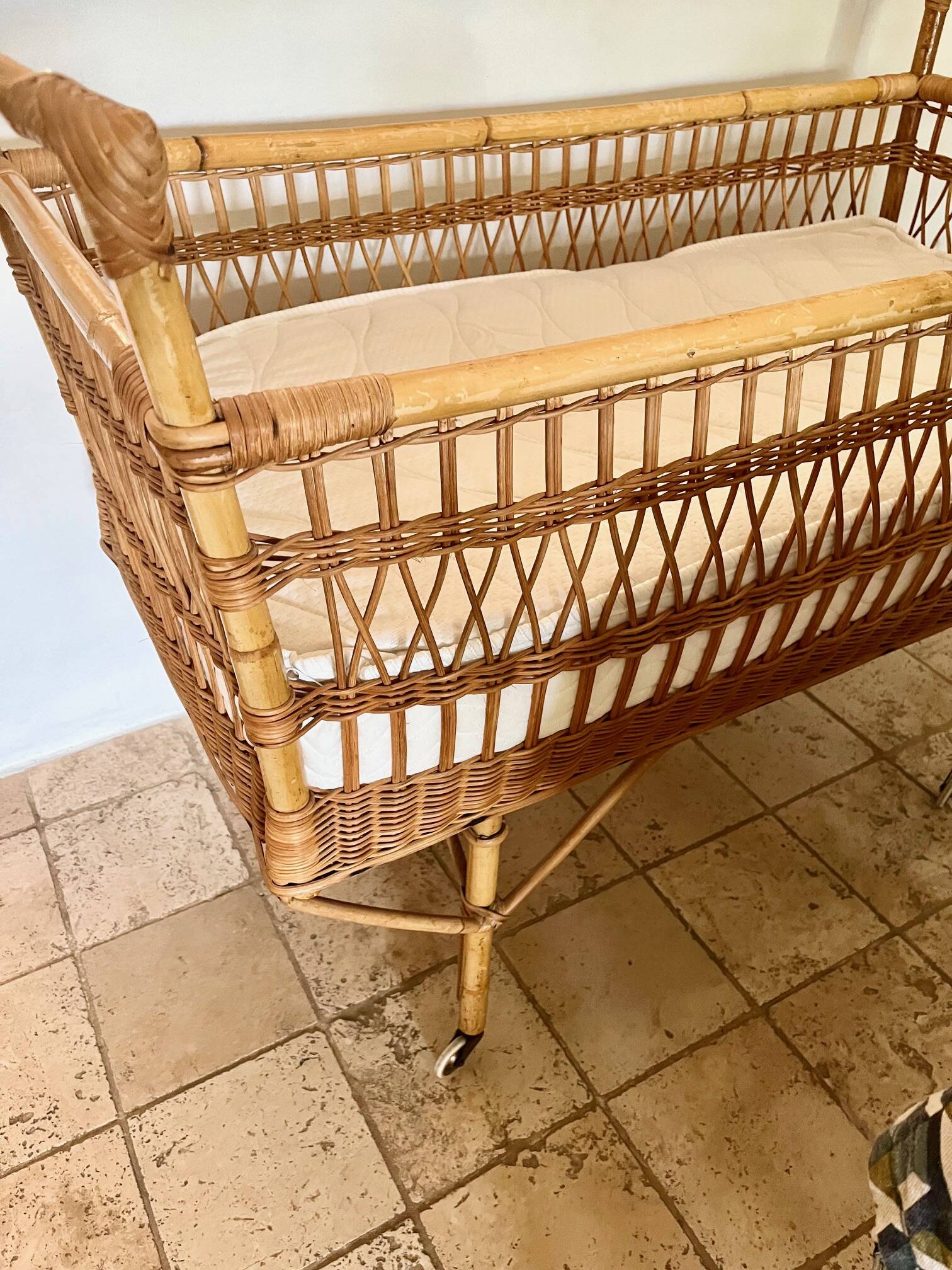 Vintage rattan baby bed with wheels