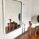 White tubular metal wall mirror