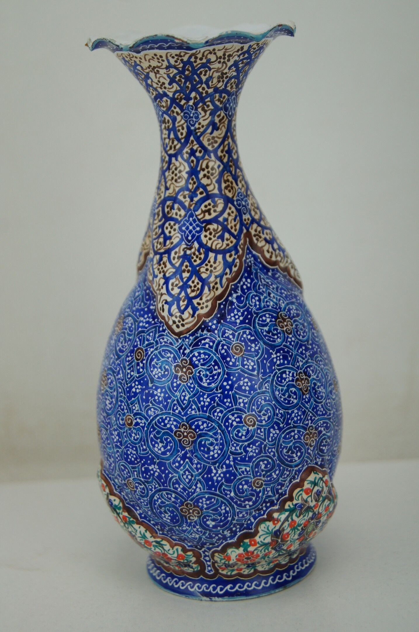 Piriform vase with a flared metal collar enamelled with a polychrome decoration, marked "Amini Iran" on the reverse.