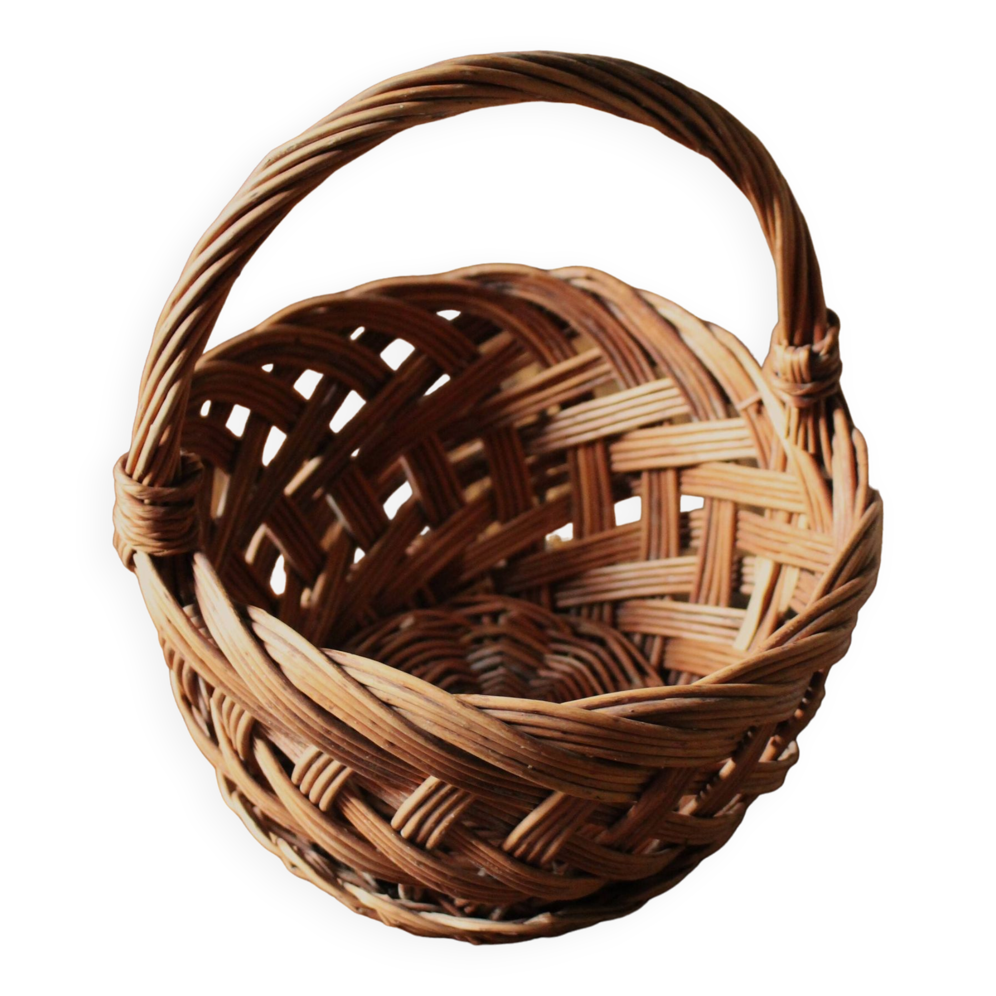 Round woven dark wicker basket with openwork vintage handle