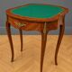 Half-moon gaming table in Louis XV style, made of precious wood marquetry.