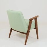 Pastel pistachio wool fabric Scandinavian armchair, oak wood.