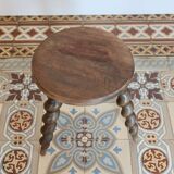 Antique tripod stool made of turned wood.